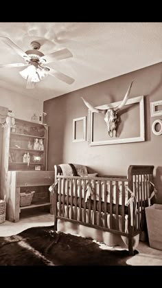 a baby's room with a cow head on the wall