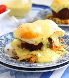 two plates with food on them, one has an egg and the other has french fries