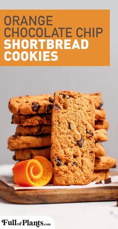 orange chocolate chip shortbread cookies stacked on top of each other with an orange slice