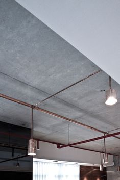 an empty kitchen with lights hanging from the ceiling