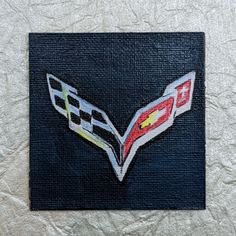 the chevrolet logo is painted on a black canvas with red, yellow and white stripes