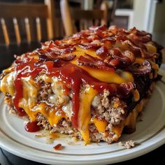 a plate topped with meat and cheese covered casserole on top of a table