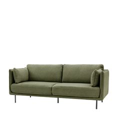 a green couch sitting on top of a white floor next to a black metal frame