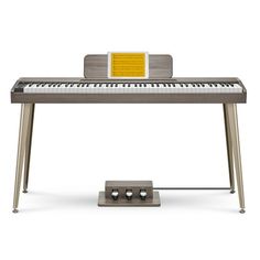 an electronic keyboard sitting on top of a metal stand in front of a white background