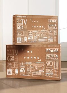 two cardboard boxes sitting on top of each other in front of a wall with the words frame