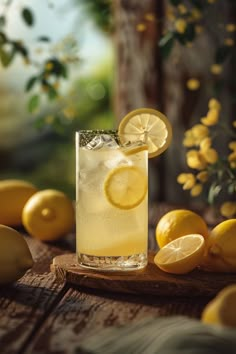 a glass filled with lemonade sitting on top of a wooden table next to lemons