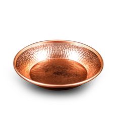 a large copper plate on a white background with no one in it or the bowl is empty