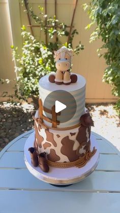 a giraffe themed cake is sitting on a table