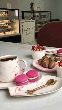 a table topped with plates of food and cups of coffee