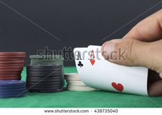 playing cards and chips on green table with black background, close - up view from the top