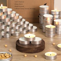 many candles are arranged on a table with nuts