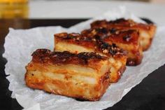 three pieces of food sitting on top of wax paper