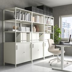 a room with a desk, bookshelf and chair in it that is white