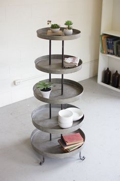 a three tiered shelf in the corner of a room