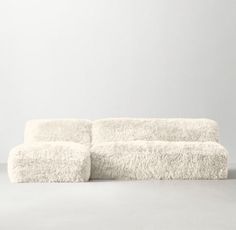 a white couch sitting on top of a gray floor