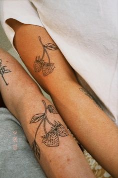 two people with matching tattoos on their legs