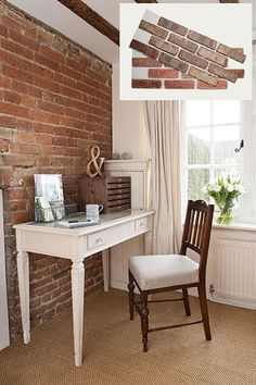 a chair and desk in a room with exposed brickwork on the wall above it