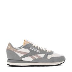 This Reebok Classic Leather is the most stylish and timeless sneaker to hit shelves. Featuring lightweight cushioning and a low-cut design, this casual men's sneaker is perfect for all-day wearing and versatile styling. Dress this sneaker up in slacks, or dress them down with sweatpants and a fitted tee. Soft leather upper. Removable sockliner accommodates orthotics. Die-cut EVA midsole for lightweight cushioning. High abrasion rubber gum outsole for durability. Imported. Classic Gray Sneakers For Streetwear, Classic Gray Sneakers With Cushioned Footbed, Classic Gray Lace-up Sneakers, Gray Sporty Sneakers With Perforated Toe Box, Gray Gum Sole Sneakers For Streetwear, Classic Gray Sports Sneakers, Classic Gray Sneakers For Sports, Gray Low-top Sneakers With Gum Sole, Gray Low-top Sneakers With Perforated Toe Box