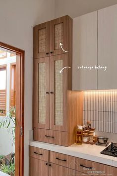 a kitchen with wooden cabinets and white counter tops