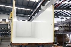 a large white box sitting inside of a warehouse