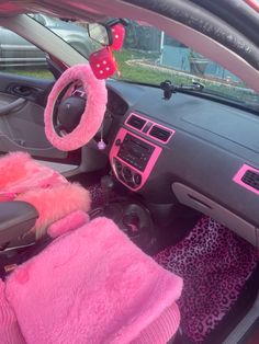 the interior of a car with pink and black accessories