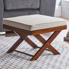 a foot stool sitting on top of a rug next to a couch