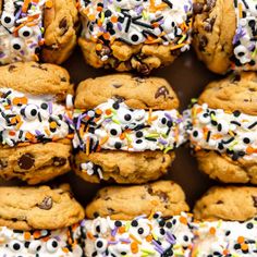 chocolate chip cookies with sprinkles and white frosting are stacked on top of each other