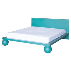 a bed with blue wheels on it and a white mattress in the middle, against a white background