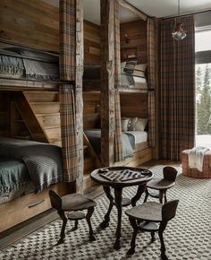 a room with bunk beds and tables in it