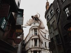 an old building with a giant dragon statue on top