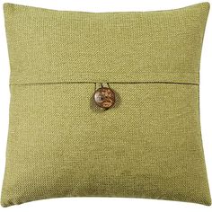 a green pillow with a button on it