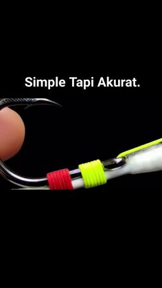 a hand holding a fishing hook with the caption simple tapi akurat