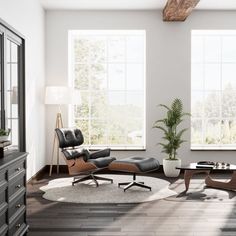 an empty living room with two large windows and a leather chair in the middle, next to a coffee table