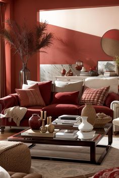 a living room with red walls and furniture