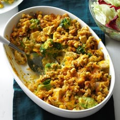 a casserole dish with broccoli and other food items on the side