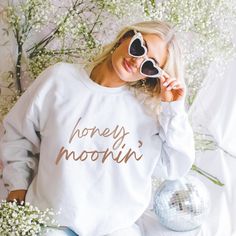 Just married and ready to cozy up in style!  This unisex sweatshirt is the perfect gift for the bride and groom to rock during their honeymoon. Available in multiple colors and sizes, it's a must-have for any newlywed couple. Say hello to the perfect wedding gift! This bride and groom honeymoon sweatshirt is a cozy reminder of their special day. Whether they're lounging at home or exploring their honeymoon destination, this sweatshirt is a must-have. 💑🌴  Ideal for any situation, a unisex heavy Honeymoon Sweatshirt, Honeymoon Vibes, Bride Wedding Gift, Honeymoon Gift, Gift For The Bride, Honeymoon Gifts, Wedding Gifts For Bride, Perfect Wedding Gift, Bride Gift