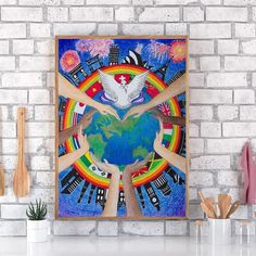 a painting on a brick wall with wooden utensils in front of it and an earth globe surrounded by hands