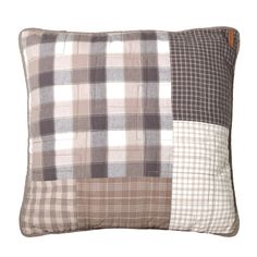 a brown and white plaid pillow on a white background