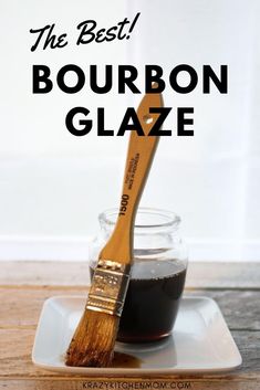 the best bourbon glaze in a glass jar with a wooden brush on a plate