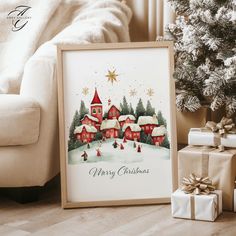 a christmas card sitting next to presents under a tree with a house in the background