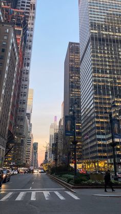 an empty city street with tall buildings in the background