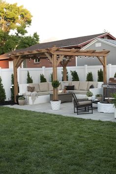 an outdoor living area with couches, chairs and a pergolated covered patio