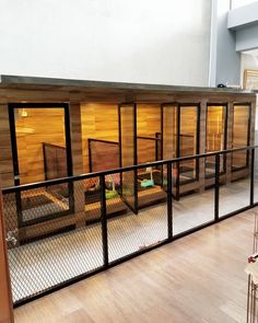 the inside of a building with wooden walls and glass doors on each side of it