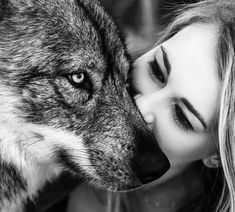 a woman and a wolf face to face