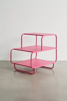 a pink and white shelf sitting on top of a cement floor