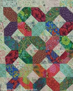 a colorful quilt with many different designs on it