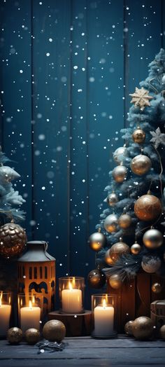 candles are lit in front of a christmas tree with snow falling on the branches and ornaments