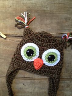 a crocheted hat with an owl's eyes