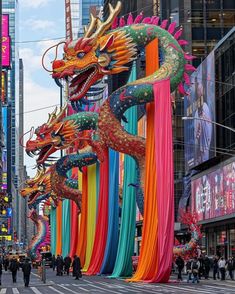 a group of colorful dragon statues in the middle of a street with people walking by