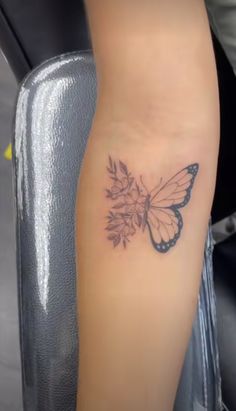 a woman's leg with a butterfly tattoo on it